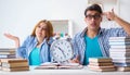 Two students runnng out of time to prepare for exams Royalty Free Stock Photo