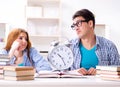 Two students runnng out of time to prepare for exams Royalty Free Stock Photo