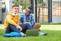 Two Students Sitting on Grass Royalty Free Stock Photo