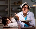 Two students studying late preparing for exams Royalty Free Stock Photo