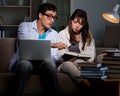 Two students studying late preparing for exams Royalty Free Stock Photo