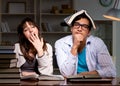 Two students studying late preparing for exams Royalty Free Stock Photo