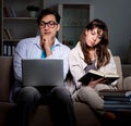Two students studying late preparing for exams Royalty Free Stock Photo