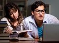 Two students studying late preparing for exams Royalty Free Stock Photo