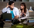 Two students studying late preparing for exams Royalty Free Stock Photo