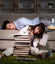 Two students studying late preparing for exams Royalty Free Stock Photo