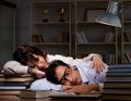 Two students studying late preparing for exams Royalty Free Stock Photo