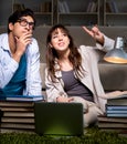 Two students studying late preparing for exams Royalty Free Stock Photo