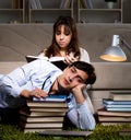 Two students studying late preparing for exams Royalty Free Stock Photo