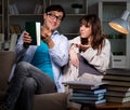 Two students studying late preparing for exams Royalty Free Stock Photo