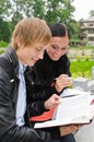 Two students studying outdoors Royalty Free Stock Photo