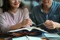 Two students studying, reading textbooks together, working on assignment and preparing for exams Royalty Free Stock Photo