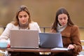 Two students studying using laptops in winter Royalty Free Stock Photo