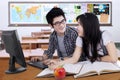 Two students talking and laughing in the class Royalty Free Stock Photo
