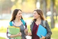 Two students talking walking in the street