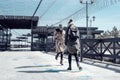 Two students walk on the street and play hopscotch on the asphalt, youth, childhood