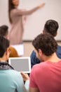 Two students watching tablet while professor giving lecture Royalty Free Stock Photo