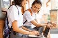 two students working on an online assignment using a laptop Royalty Free Stock Photo