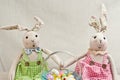 Two, stuffed, baby rabbits and easter basket of candy Royalty Free Stock Photo
