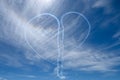 Two stunt planes create a heart out of smoke in the sky