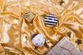 Two stylish black and white Christmas balls with stars and strips, gift box and bag on golden satin fabric