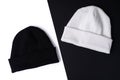 Two stylish fashion beanie hats in basic colors black and white on a black and white background