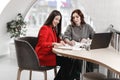 Two stylish girls interior designers working in the office at the design project Royalty Free Stock Photo