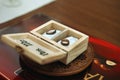 Two stylish golden engraved rings in wooden box Royalty Free Stock Photo