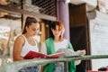 Two stylish high school girls working on a project in the city. They study together, collaborating and preparing for an Royalty Free Stock Photo