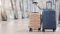 Two stylish suitcases standing in empty airport hall, panorama with copy space Royalty Free Stock Photo