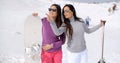 Two stylish women with their snowboards Royalty Free Stock Photo