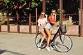 Two stylish young and girls on a bicycles in the summer Royalty Free Stock Photo