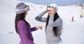 Two stylish young woman chatting at a ski resort Royalty Free Stock Photo