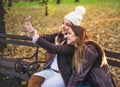 Two stylish young women taking a selfie