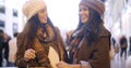 Two stylish young women in winter fashion