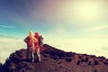 Two successful backpackers enjoy the beautiful landscape on sunrise mountian Royalty Free Stock Photo