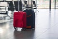 Two suitcases are on the floor in airport waiting room Royalty Free Stock Photo