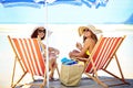 Two summer beauties on the beach. Portrait of two beautiful young women eating an ice cream at the beach. Royalty Free Stock Photo
