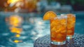 two summer citrus cocktails with ice cubes in glasses against the background of the pool, luxury summer vacation, lemonade, Royalty Free Stock Photo