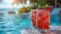 two summer strawberry cocktails with ice cubes in glasses against the background of the pool, luxury summer vacation, lemonade, Royalty Free Stock Photo