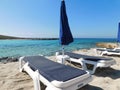 two sun beds and an umbrella on the Fig tree beach. Protaras. Cyprus Royalty Free Stock Photo