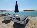 two sun beds and an umbrella on the Fig tree beach. Protaras. Cyprus Royalty Free Stock Photo