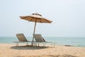 Two sun-beds and umbrella on tropical beach Royalty Free Stock Photo