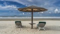 Two sun loungers with soft mattresses stand on the sandy beach Royalty Free Stock Photo