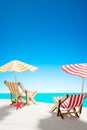 Two sun loungers under an umbrella on the sandy beach by the sea and the sky with copy space Royalty Free Stock Photo