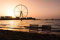 Two sunbeds with Ain Dubai ferris wheel view at JBR beach