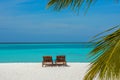 Two sunbeds on the beautiful beach at the tropical island Royalty Free Stock Photo