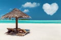 Two sunbeds under palapa on maldives beach Royalty Free Stock Photo