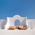 Two sunbeds on white terrace with arch. Traditional mediterranean architecture under blue clear sky. Summer vacation background.