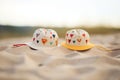 two sunhats with heart patterns lying on sand Royalty Free Stock Photo